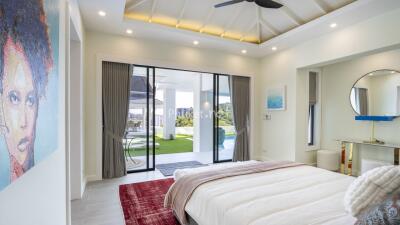 Modern bedroom with sliding glass doors opening to outdoor space