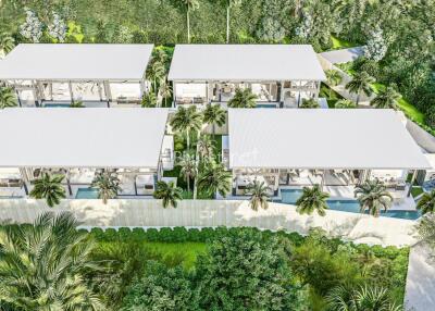 Aerial view of a modern residential complex surrounded by lush greenery