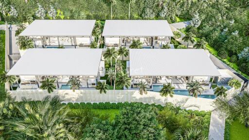 Aerial view of a modern residential complex surrounded by lush greenery