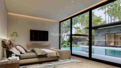 Bedroom with large windows overlooking a pool and greenery