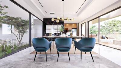 Modern dining area with large windows and blue chairs