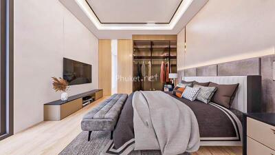 Modern bedroom with large bed, TV, seating bench, and walk-in closet