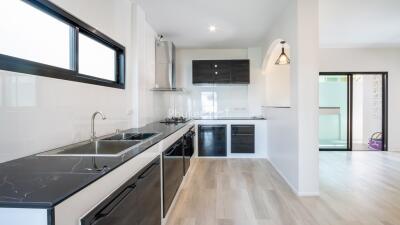 Modern kitchen with black countertops and white cabinets