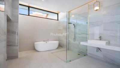 Modern bathroom with bathtub and glass shower