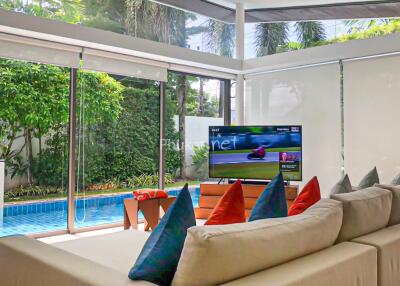 Spacious living room with pool view and modern decor