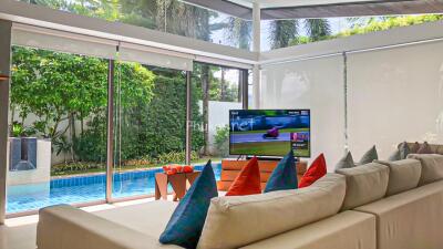 Spacious living room with pool view and modern decor