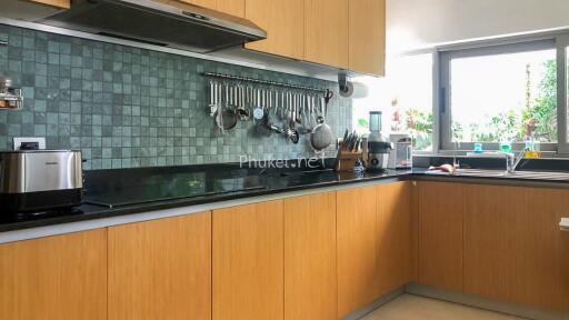 Modern kitchen with wooden cabinets and tiled backsplash