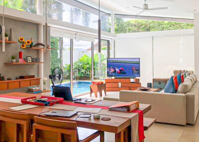 Modern living room with dining area and view of the pool