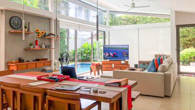 Modern living room with dining area and view of the pool