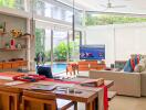 Modern living room with dining area and view of the pool