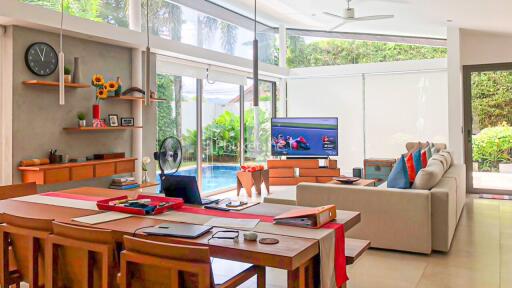 Modern living room with dining area and view of the pool