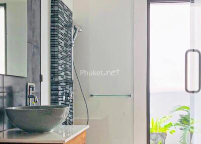 Modern bathroom with sink, shower, and large window