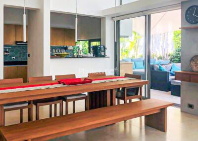 Modern dining area with wooden furniture and view of outdoor seating