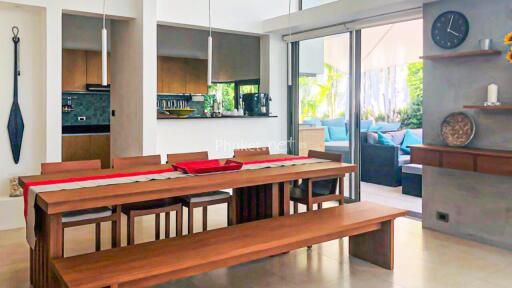 Modern dining area with wooden furniture and view of outdoor seating
