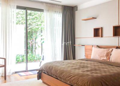 Bedroom with large window and garden view