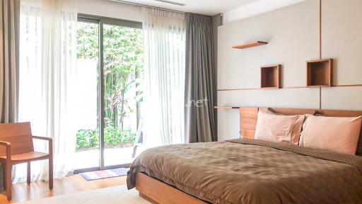 Bedroom with large window and garden view