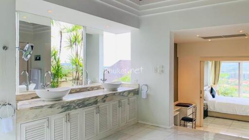 Bathroom with dual sink vanity and adjacent bedroom