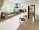 Modern kitchen with breakfast bar and adjacent dining area