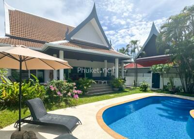 Modern house with poolside and lush garden