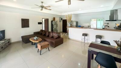 Spacious living room with modern furniture and open kitchen