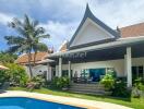 Exterior view of a luxury villa with swimming pool in a tropical setting