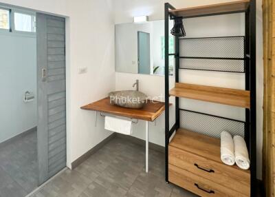 Modern bathroom with vanity sink and open shelves