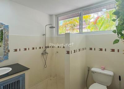 A modern bathroom with a shower and toilet