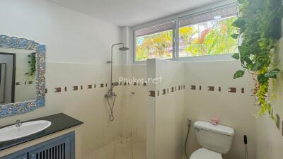 A modern bathroom with a shower and toilet