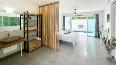 Bright and spacious bedroom with a poolside view