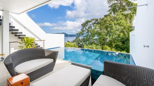 Outdoor seating area with pool and scenic view