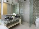 Modern bathroom with dual sinks and glass shower enclosure