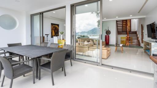 Modern living space with outdoor dining area and lake view