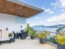 Rooftop patio with scenic view of a lake and mountains