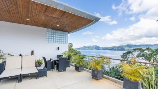 Rooftop patio with scenic view of a lake and mountains