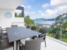 Outdoor dining area with a view of the sea and surrounding greenery