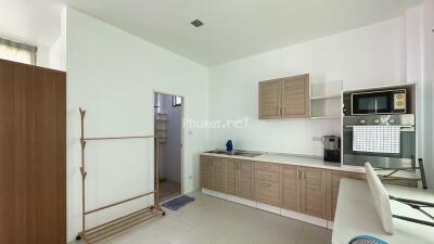 Modern kitchen area with wooden cabinets and appliances