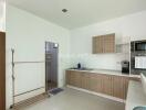 Modern kitchen area with wooden cabinets and appliances