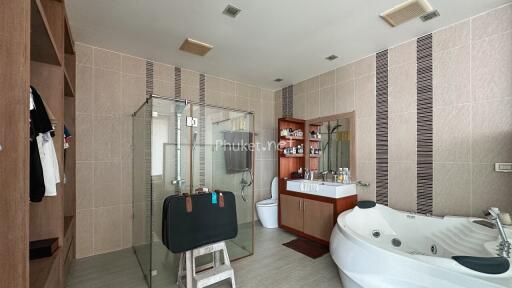 Spacious modern bathroom with glass shower and bathtub