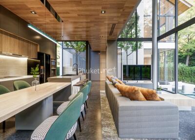 Modern open-plan kitchen and living area with large windows and green views