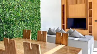 Modern living room with vertical garden and wooden furniture