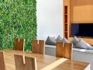 Modern living room with vertical garden and wooden furniture