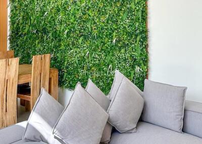 living room with green wall and wooden dining set