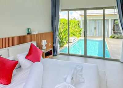 Bedroom with pool view and modern decor