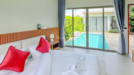 Bedroom with pool view and modern decor