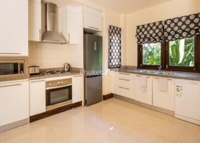 Modern kitchen with stainless steel appliances and large windows