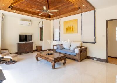 Cozy living room with wooden accent ceiling and modern furniture