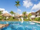 Luxurious pool area with palm trees and villas