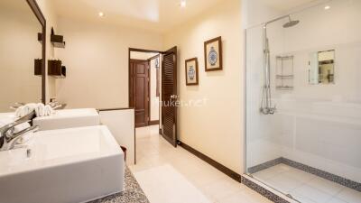 Modern bathroom with double sinks and shower area