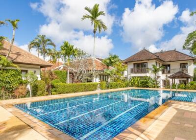 Beautiful outdoor pool with surrounding tropical landscaping