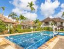 Beautiful outdoor pool with surrounding tropical landscaping